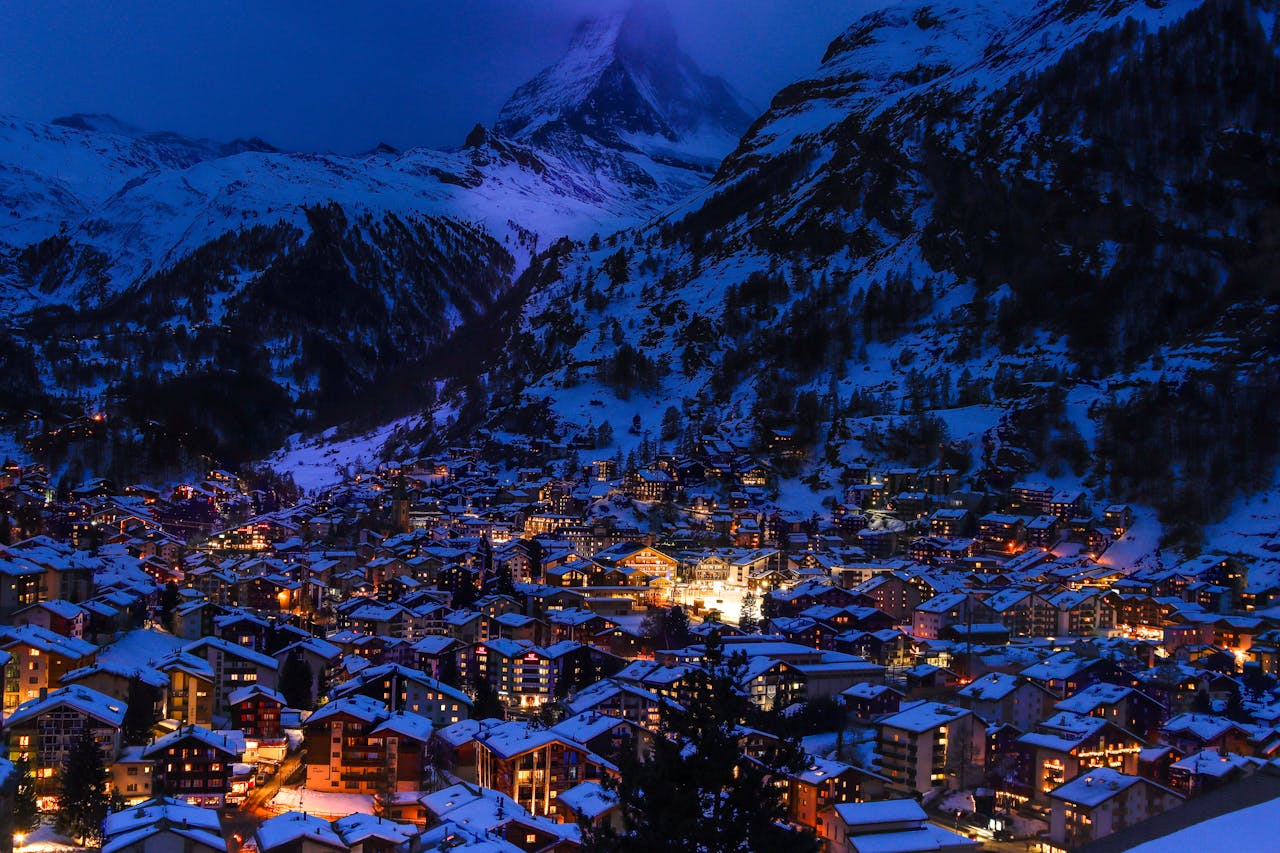 A picturesque village with chalets and snowy mountains