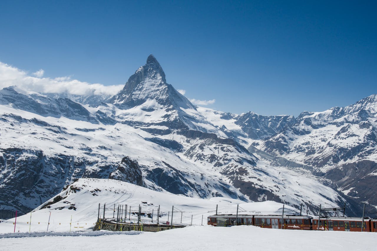 A train winding through a snowy mountain landscape