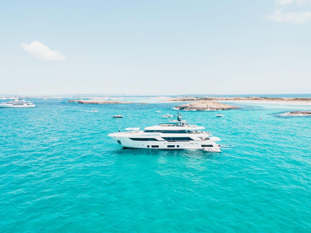 Boat sailing on clear blue water in Ibiza Vacation Guide